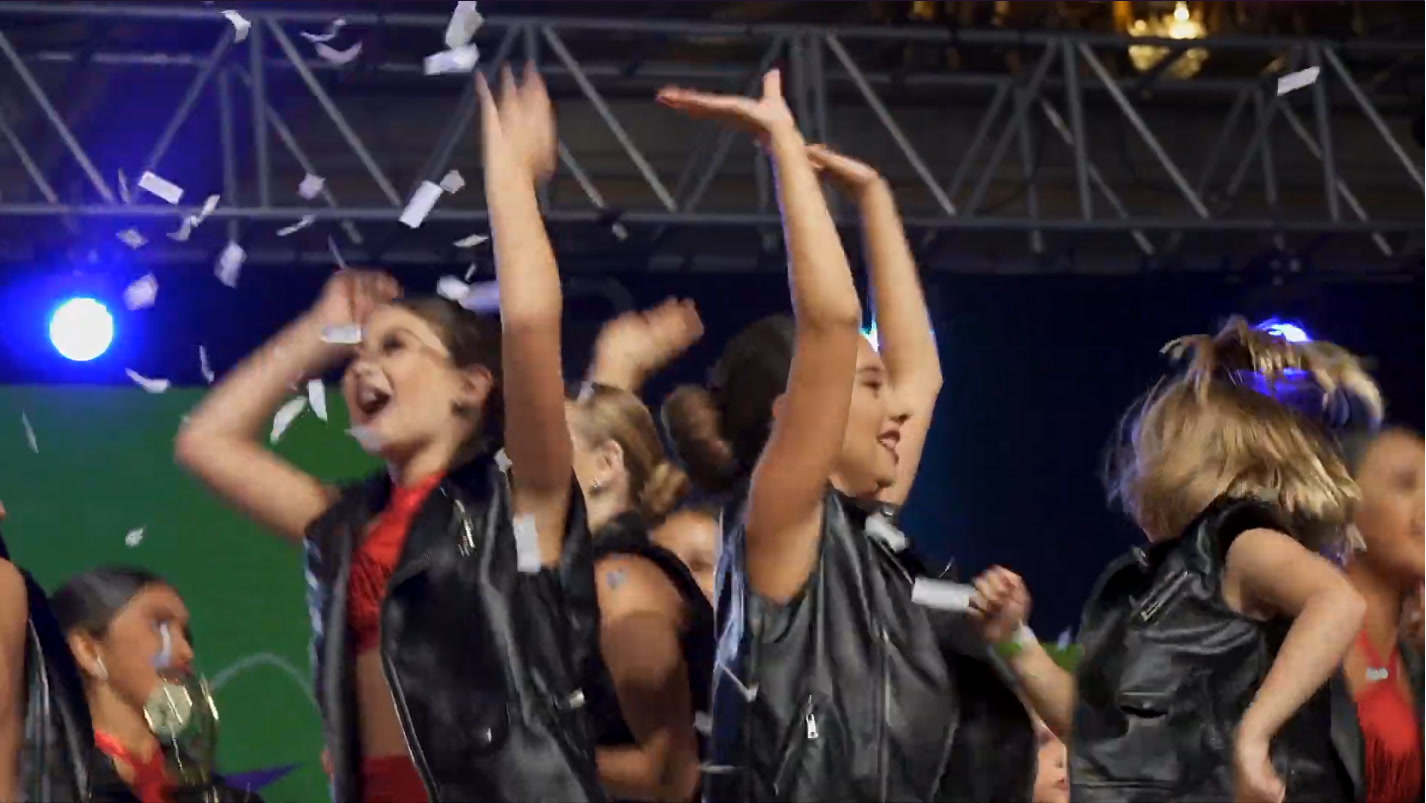 Dancers throwing their hands up in celebration in the National Finals recap film